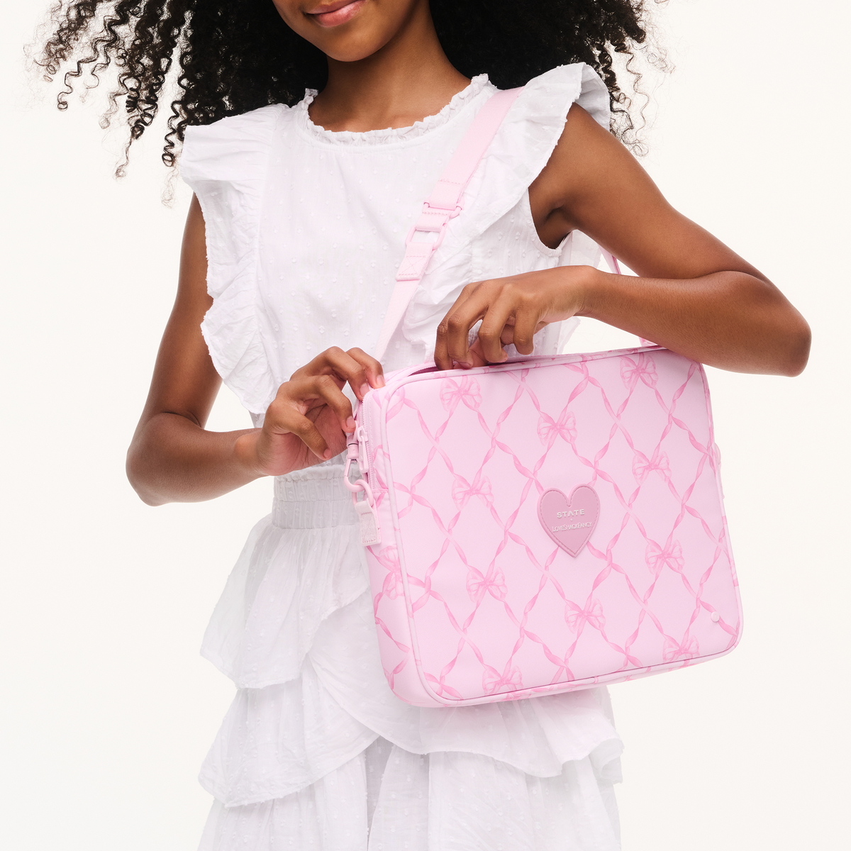 Girl wearing STATE x LoveShackFancy Allen Laptop Case