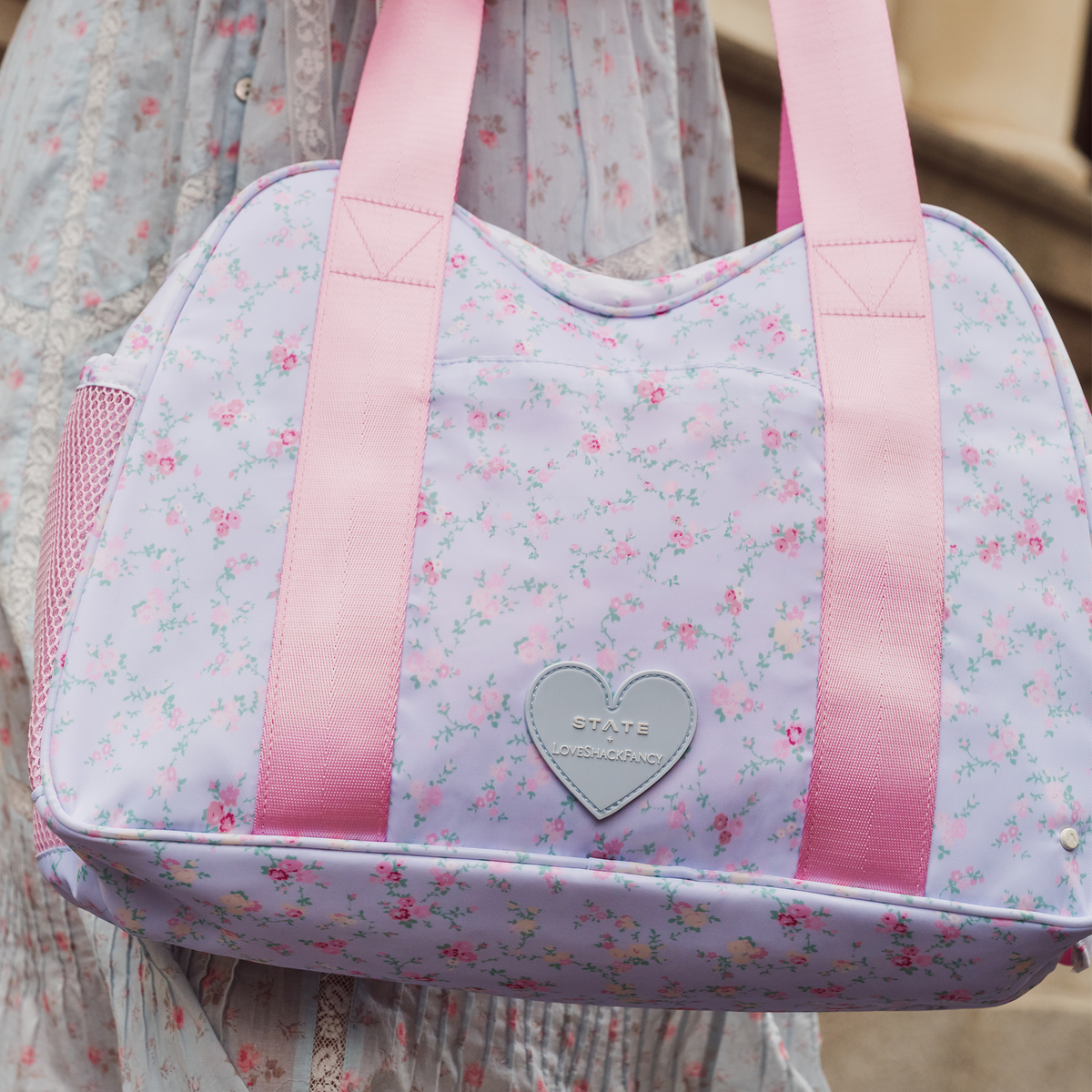 woman wearing STATE x LoveShackFancy Bella Diaper Tote Confetti Bloom / Wildflower Blue