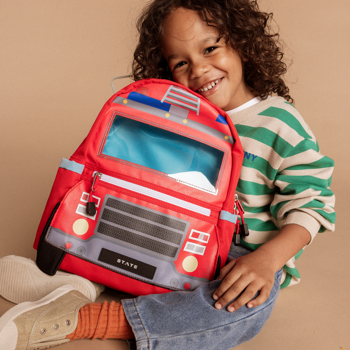 boy holding state bags kane mini firetruck