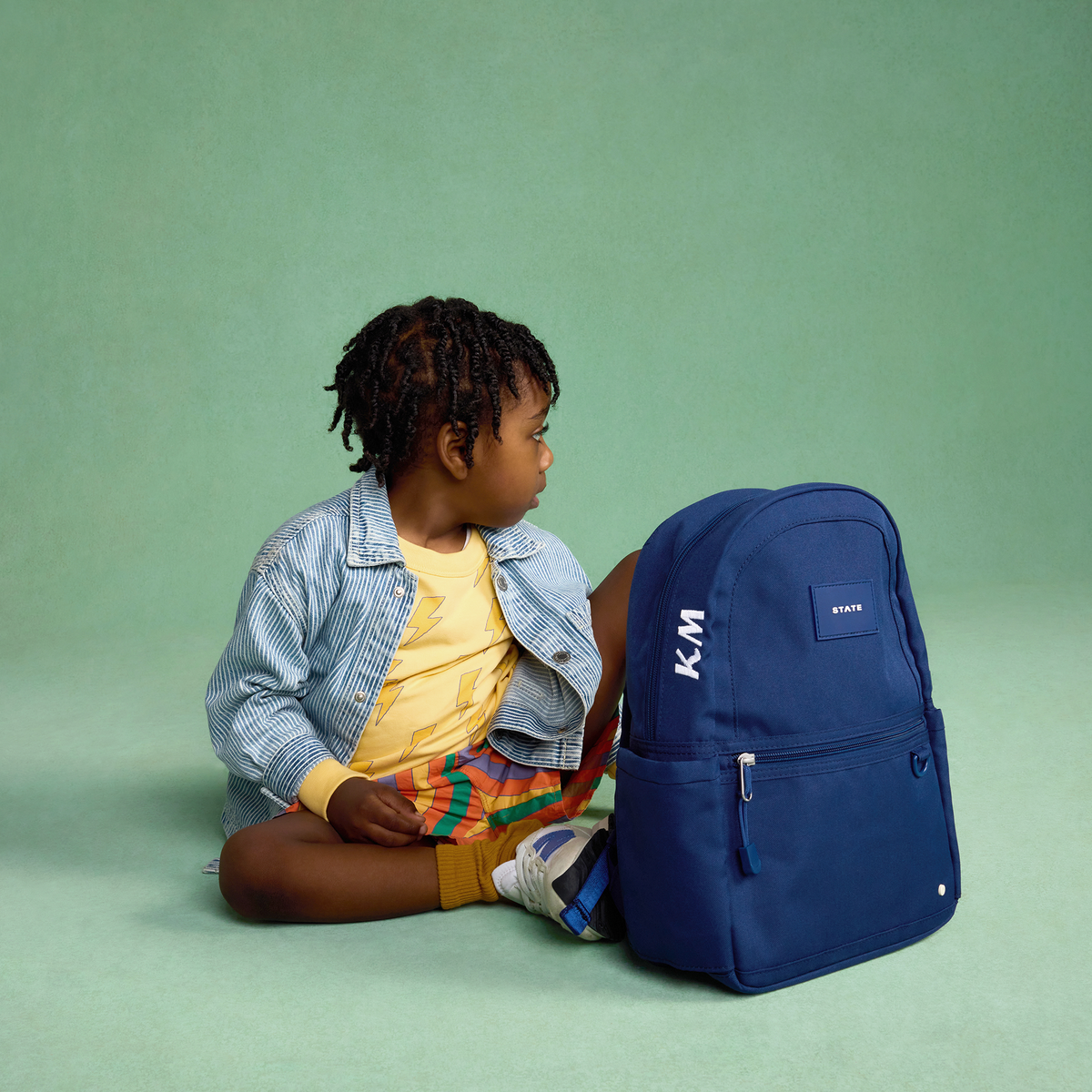 boy sitting with kane mini navy 