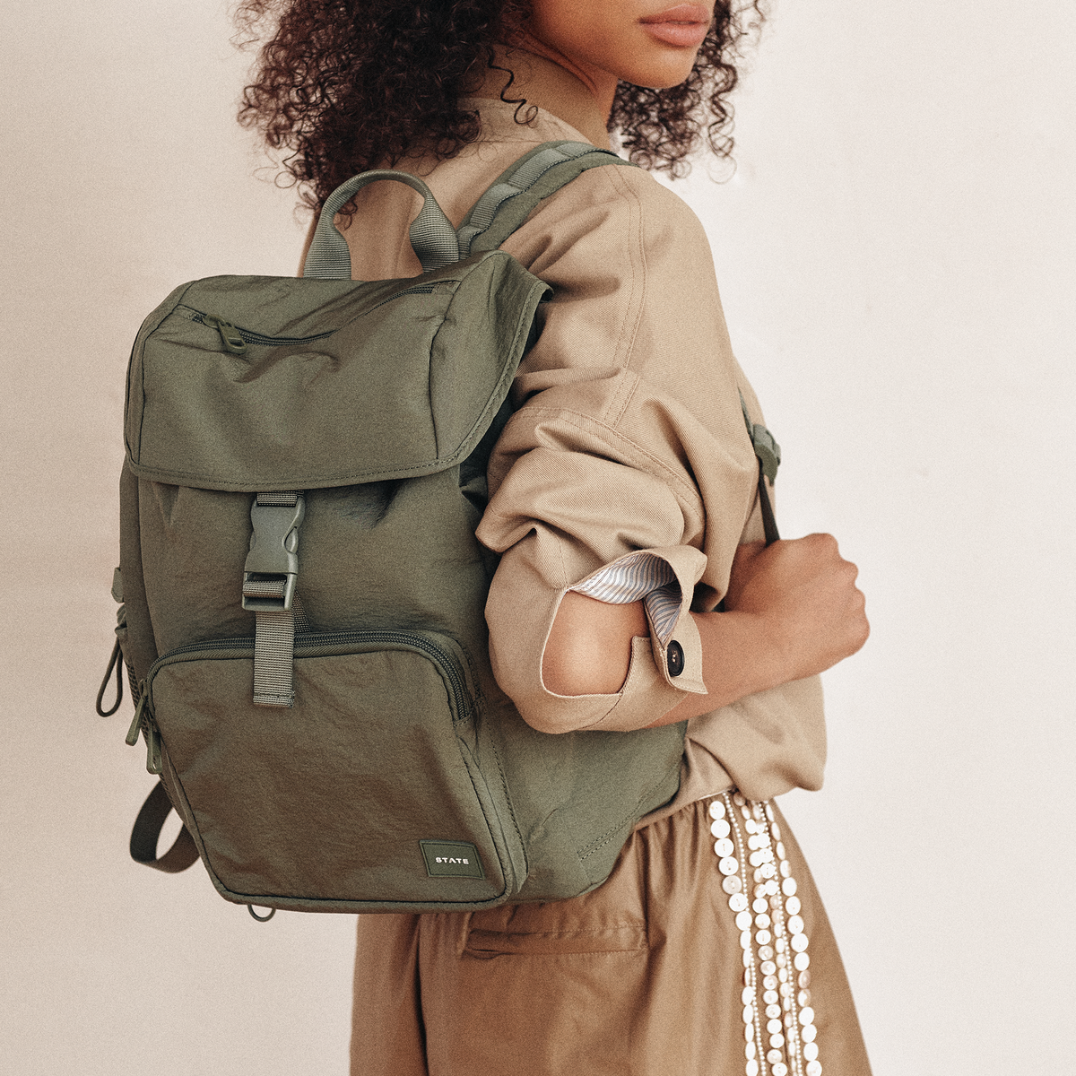Woman wearing STATE Bags Nevie Backpack Olive