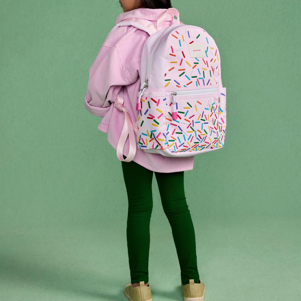 girl wearing STATE Bags kane mini backpack sprinkles