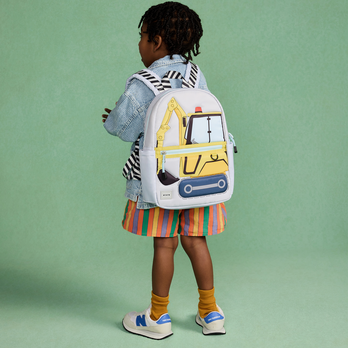 boy wearing STATE Kane Mini Backpack construction