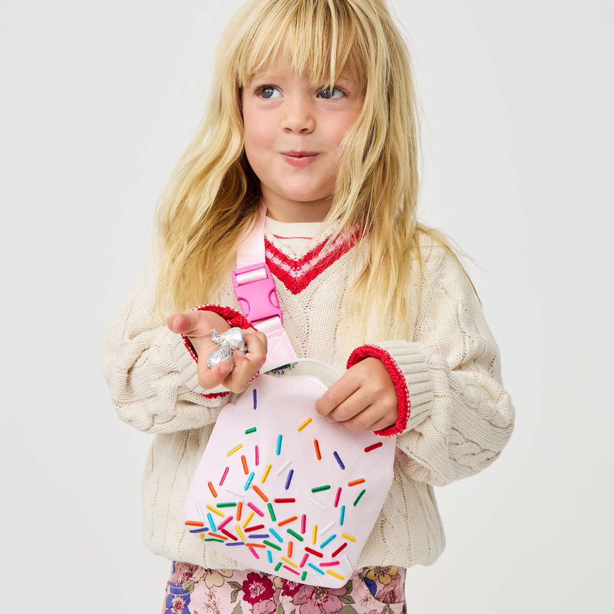 girl holding sunny kids fanny pack sprinkles