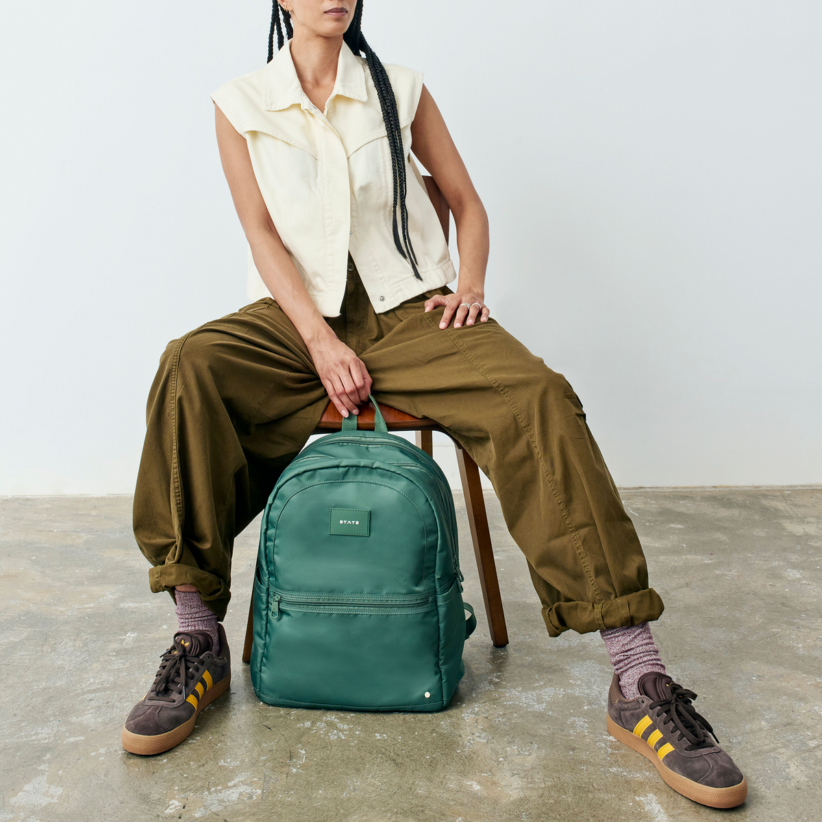 woman sitting with STATE Bags Evans Double Pocket Olive 