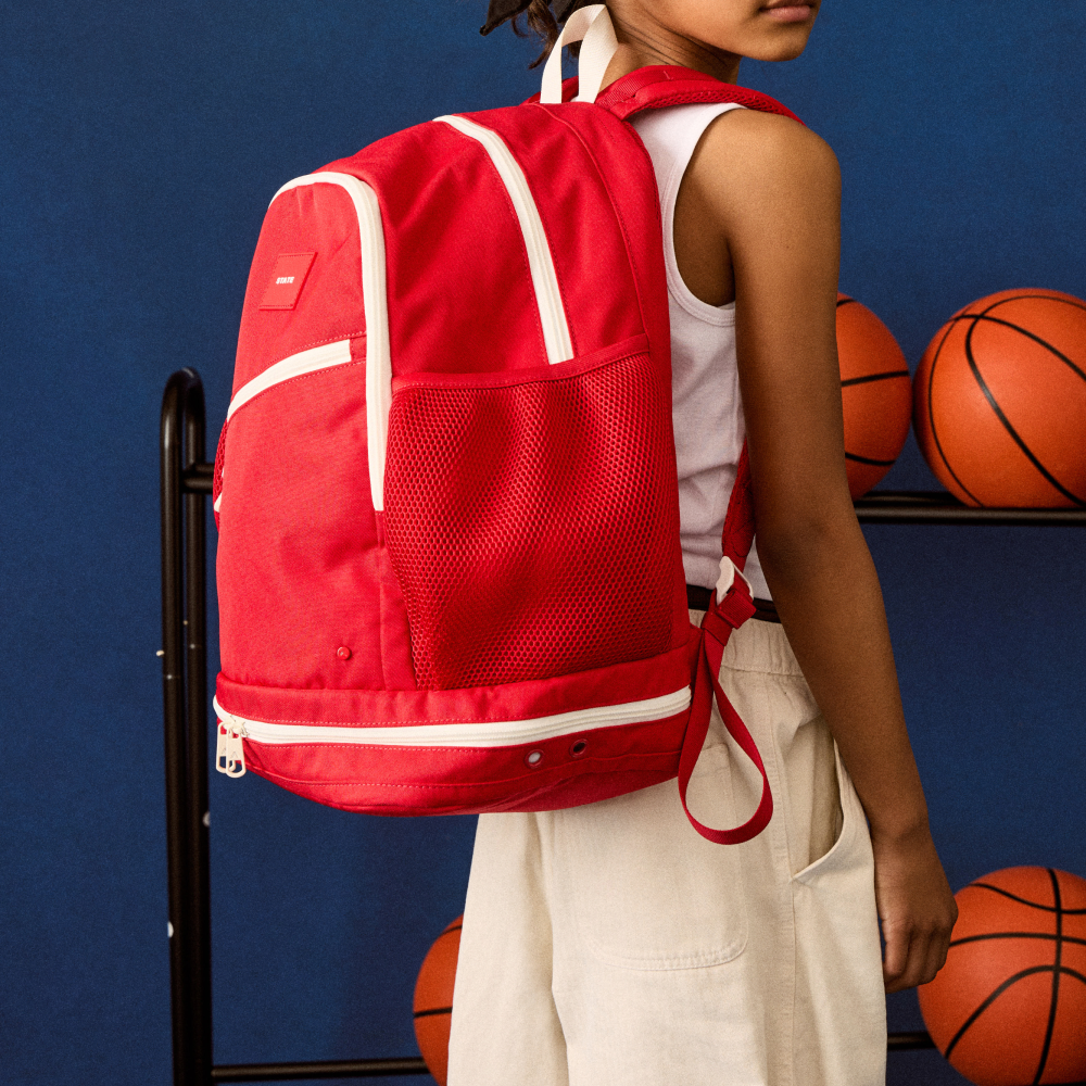 girl wearing STATE Bags Ozzie Ball Bag red